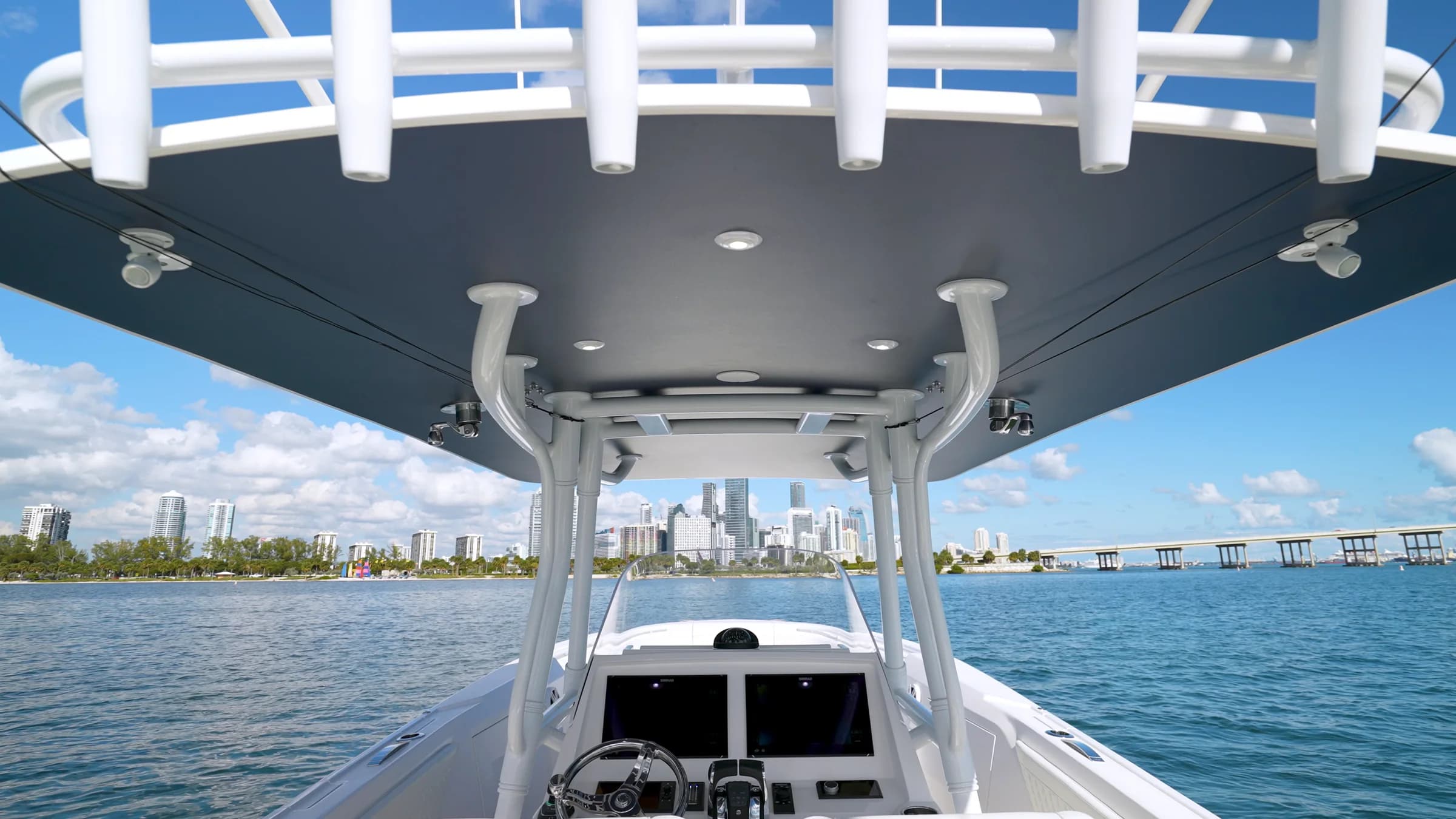 Looking forward under the hardtop toward a city skyline across the bay