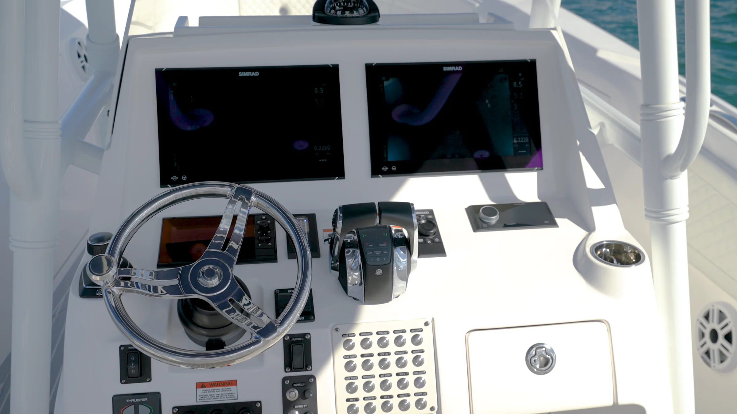 The helm: twin displays, a stainless wheel and the throttles